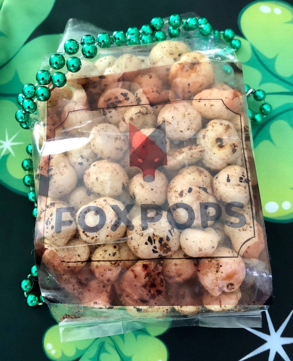 Clear bag of FOXPOPS fox nuts with the geometric fox logo
